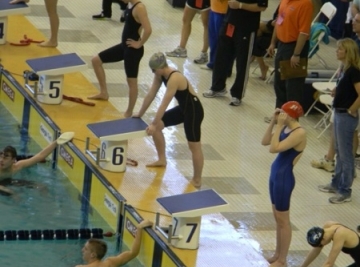 Kaylyn Thomas prepares for battle behind the diving blocks at the 2013 State Championships. 