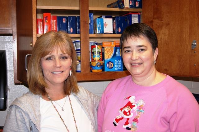 MI/MO instructor Mrs.Coffey and Mrs.Gilbert organize the food pantry in preparation for the canned goods to be sent out to children in need this Christmas.