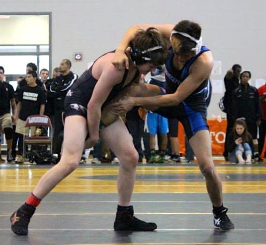 A North Forsyth wrestler fights hard to outsmart their competing wrestler.