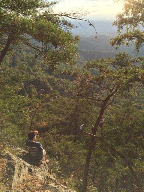 Overlooking the beautiful mountains in the Fort Mountain State Park, Senior Eric Decker relaxes on a rock after a long hike on the Gahuti Trail. 
