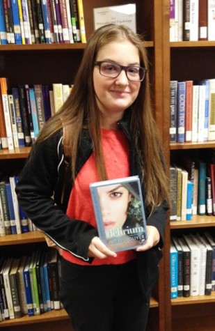 Freshman Allison Frady holds a copy of Delirium by Lauren Oliver. “I love reading because it takes you to different places.” Frady said.
