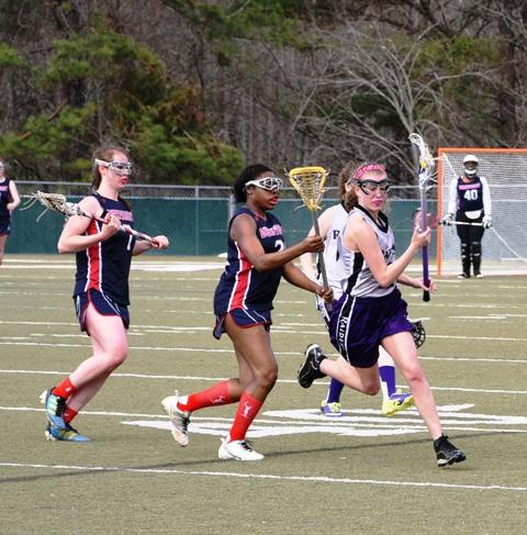 Senior Rachel Hejduk (#2) scoops up the ball and races towards the attack end of the field. Lady Raiders scored successfully nineteen times while they only gave up eight points. 