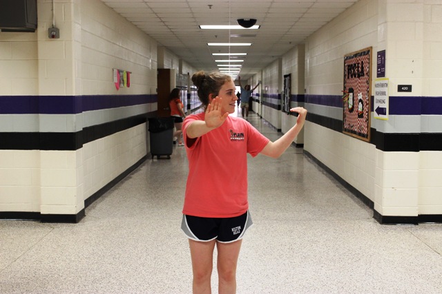 In this photo taken by Leilani Gibbons, Danielle Gibbs imitates directing traffic in the hallway.