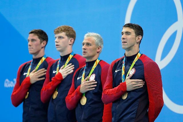 Michael Phelps (far right) poses next to Ryan Lochte and two other members of the gold-medal 4x200 meter freestyle relay foursome. The team beat Great Britain for first place by less than two seconds with a time of 7:00.26 (picture from Wikipedia).