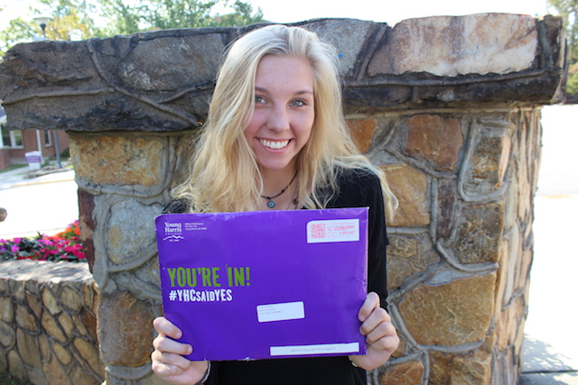 Sara Chesnut holds up her acceptance letter to Young Harris College. She is excited to attend the same college as her father, sister and many other family alumni.