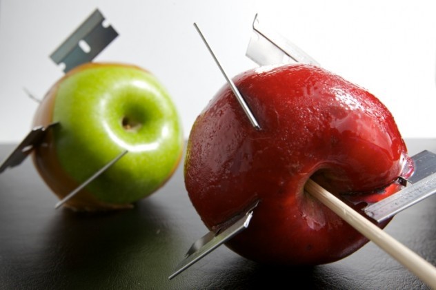 Even though this picture of razor bladed candy apples is staged, the dangers in real life during Halloween are not.