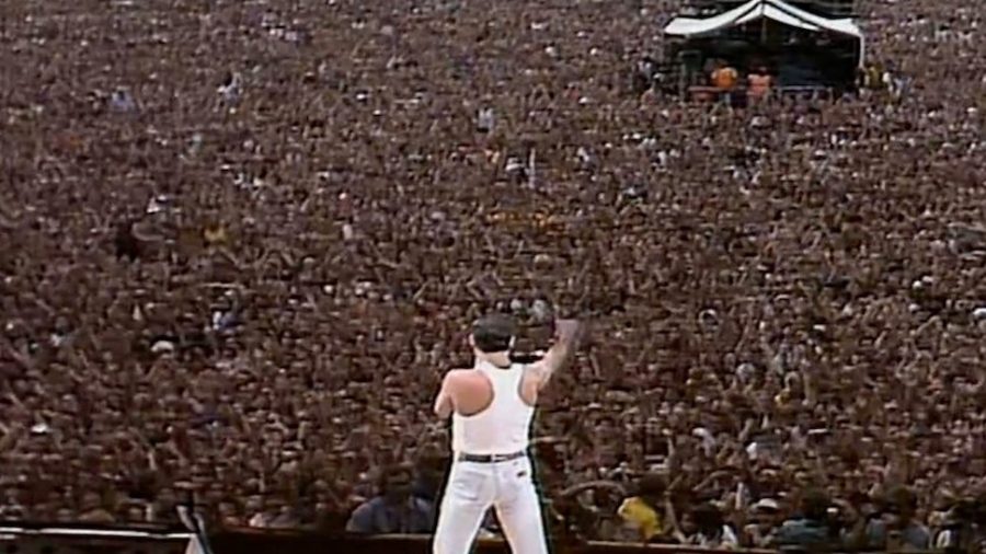 Freddie Mercury stands tall before the Live AIDS concert crowd and delivers a heartfelt performance of Queen’s greatest hits. It was one of the largest concert crowds recorded. Freddy Mercury is one example of an artist who remained un-corrupt by the industry 
 (Photo Credits: https://www.943thedrive.ca/2018/11/16/20734/.)