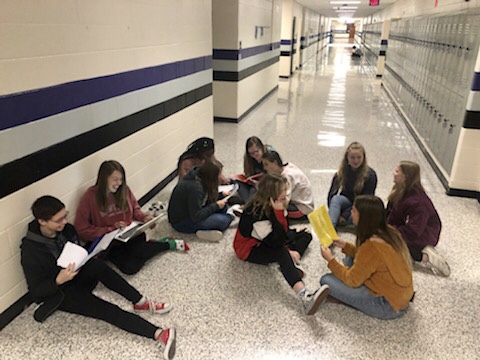Group of freshman journalists working out in the halls. 