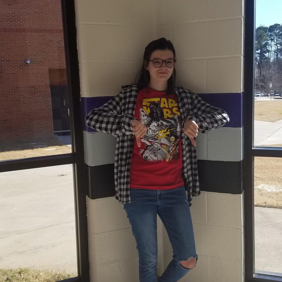 Senior Grace Wood , a long time Star Wars fan, is showing her support for the franchise by wearing a classic Star Wars shirt. She is also showing her disdain for the newest installments by giving two thumbs down.
