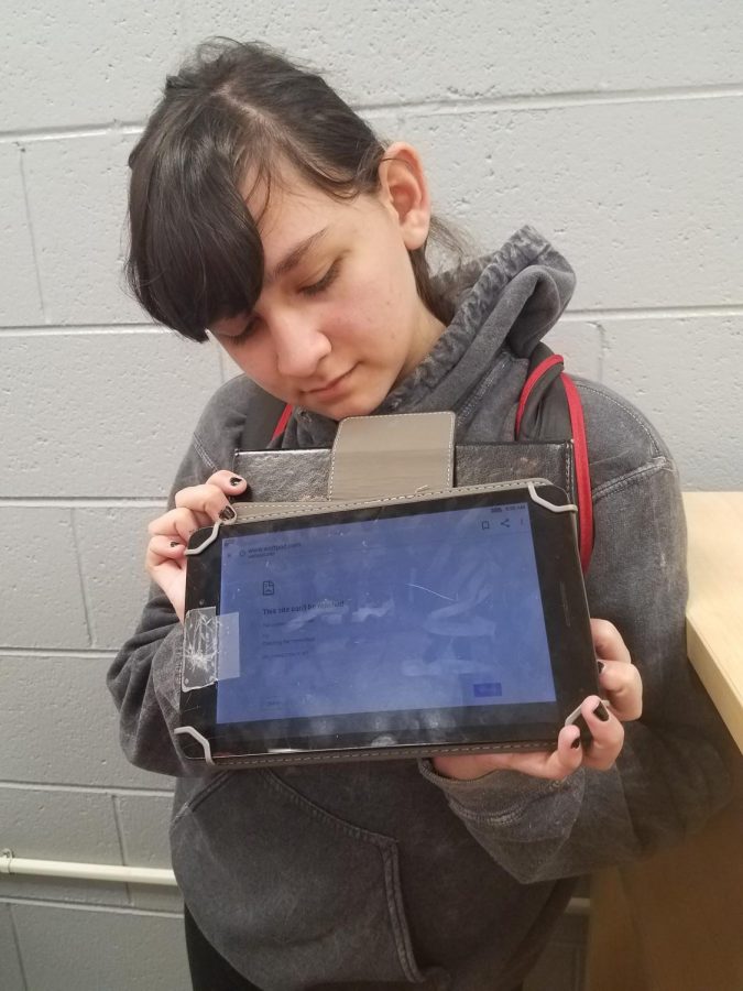 Freshman Zoe Smith is Holding up her device, showing that Wattpad doesn’t work on our school’s wifi.