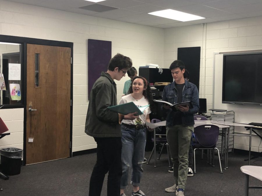 Three students acting and reading the script in the final auditions.
