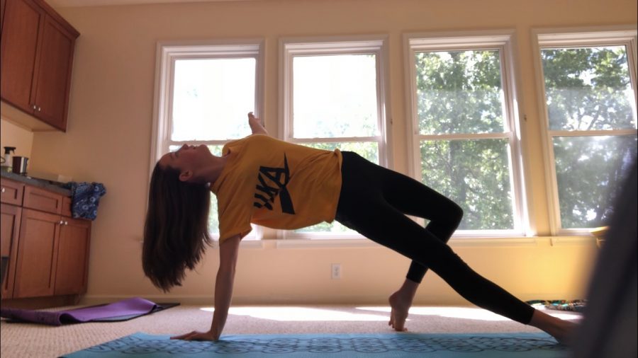 Freshman Varsity Swimmer Julia Wickman practices yoga to remain fit during quarantine. The Swim Team is having a competition to see which group can complete the most amount of workouts or physical activities, and the winners receive a surprise.