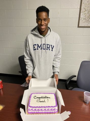 Senior Daniel Adesina posed with his celebratory cake gifted to him by North’s counseling network. It was marble with strawberries. Photo submitted by Daniel Adesina.