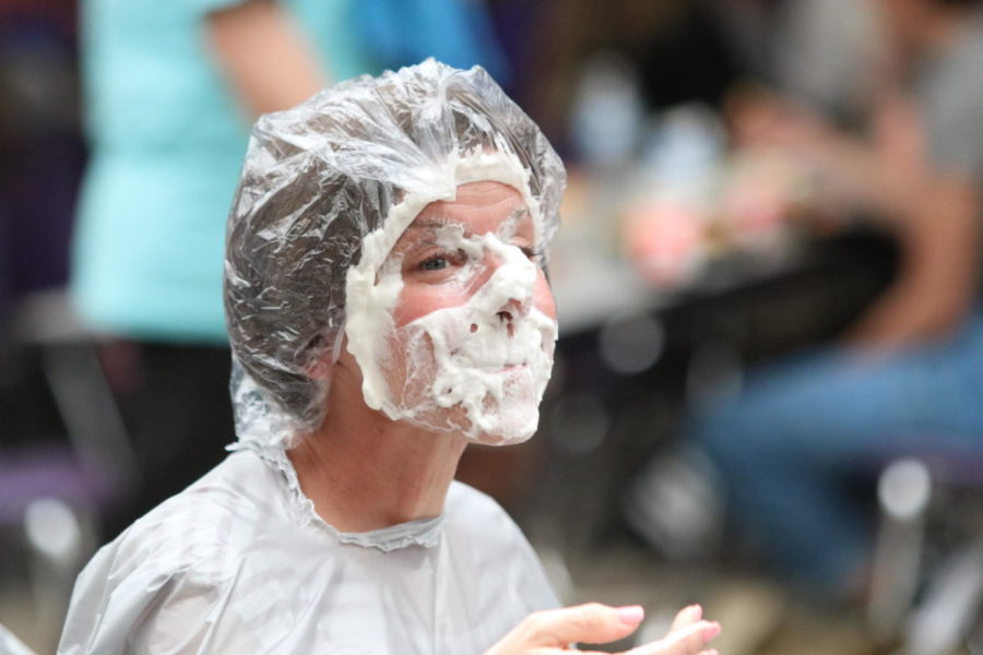 Assistant principal Angela Loftus was found victim to whipped cream but was luckily protected by a shower gap and plastic bib. Photo by Sydney Jarrard.  