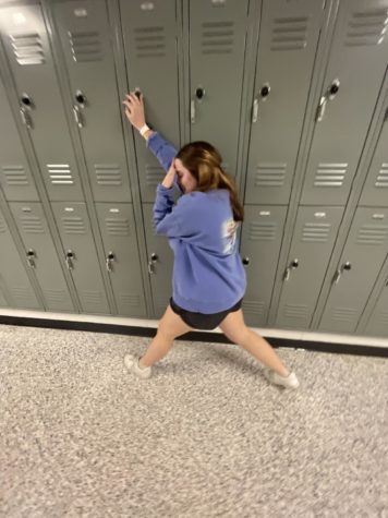 Photo caption: Senior Reagan McMichen showed how it feels to be run into in the hallway when you are just trying to get to class on time and demonstrates how not to stop in the hallway (Photo by Sarah Treusch)