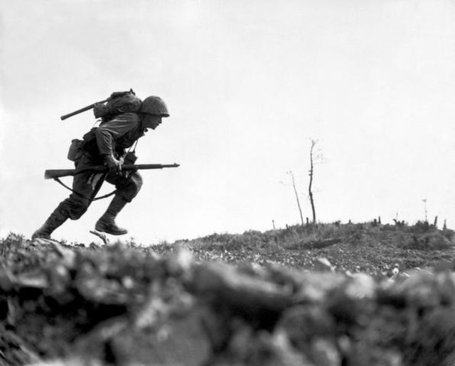 Photo of a soldier running in battle
