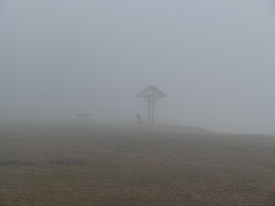 An eerie landscape distorted by dense fog.