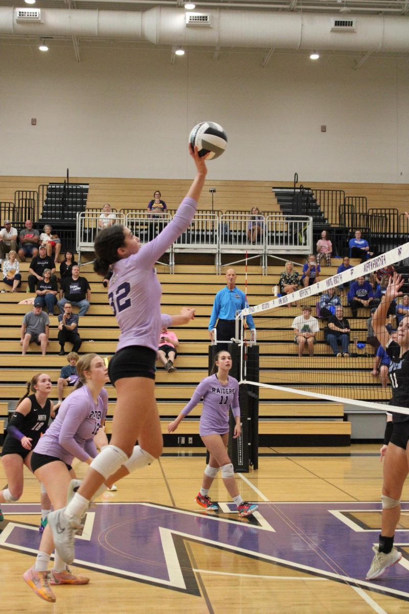 Sophomore Jayda Reece spiking the ball at the game against South.