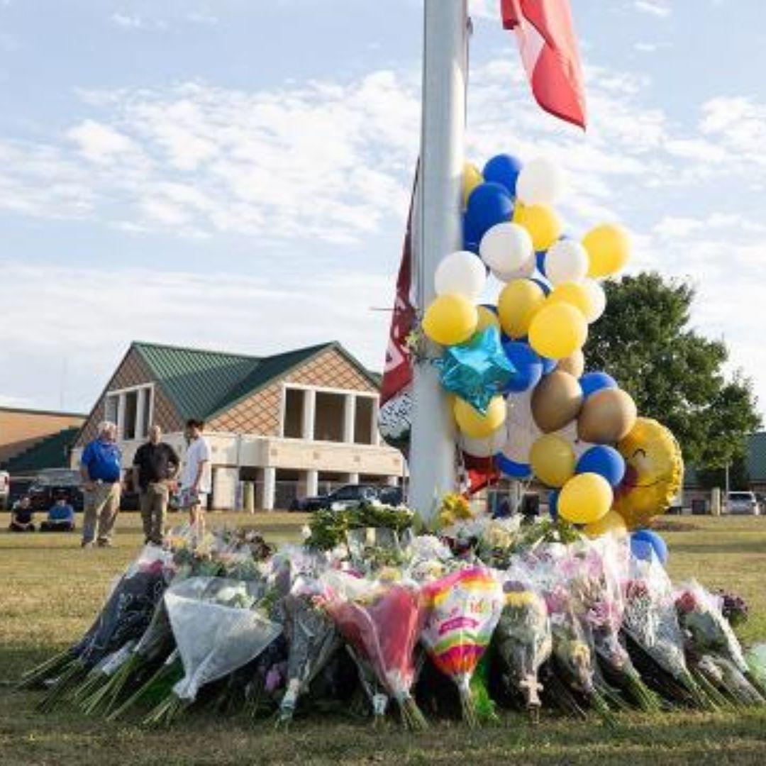 Memorial created at the flagpole at Apalachee High School for the ones killed in the tragedy.