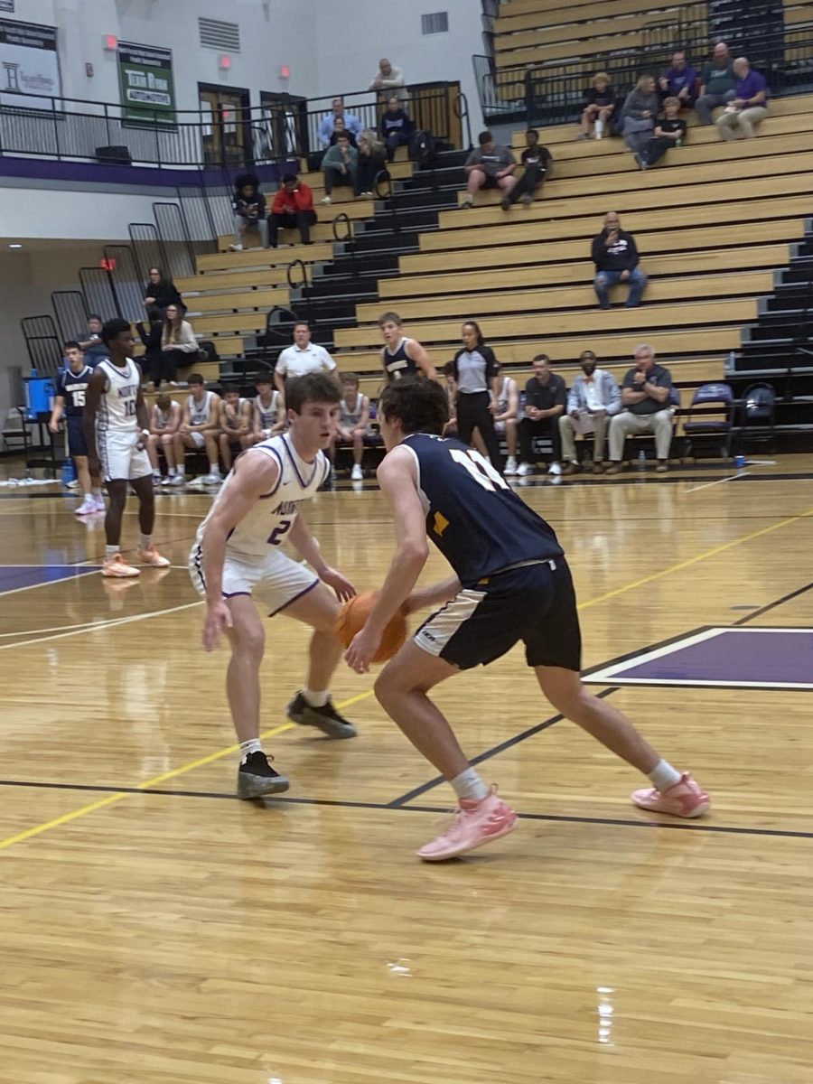 Brogen Casey, a senior at North, attempts to steal the ball from the Warriors.