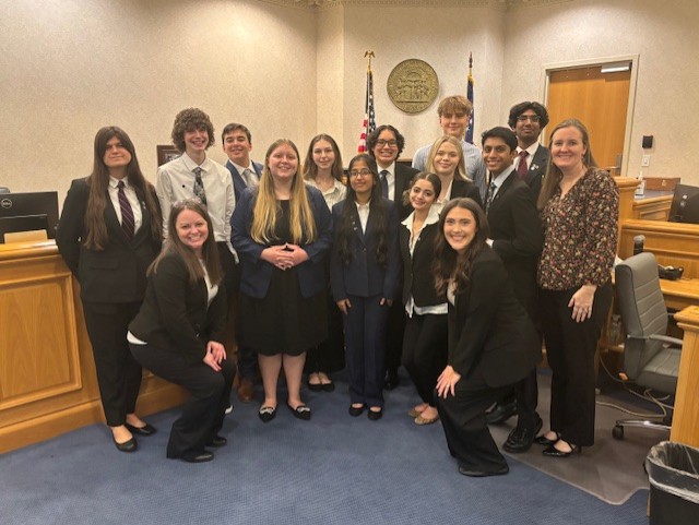 The Mock Trial team together in the courtroom