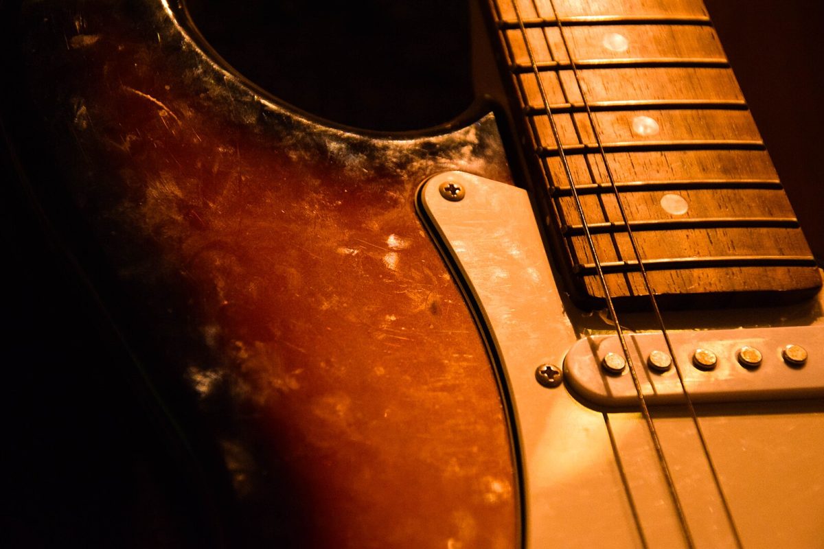 A rustic, nostalgic guitar collecting dust.
